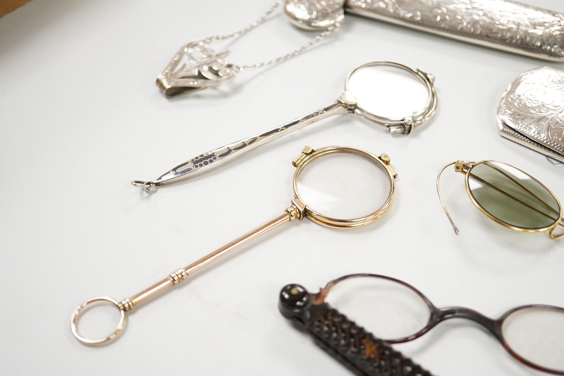 An Edwardian engraved silver spectacle case, by Boots Pure Drug Company, Chester, 1903, one other engraved silver spectacles case, hallmarks rubbed, a pair of 830 standard white metal and niello lorgnettes, two other pai